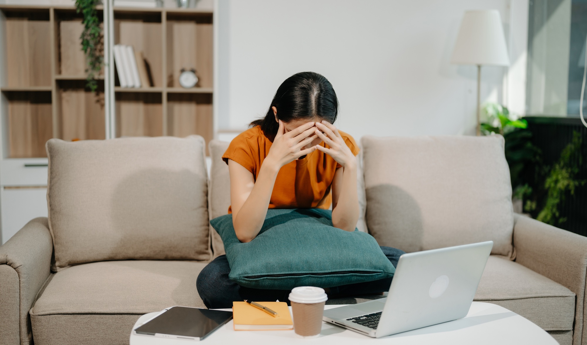 Woman who is tired and overthinking from working with tablet